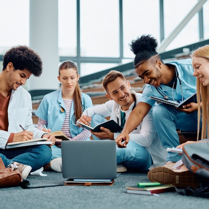 Group of happy medical students using laptop.